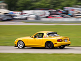 Yellow Mazda Miata on the track at Autobahn Country Club