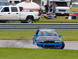 Blue BMW M3 Splashing into water on the track