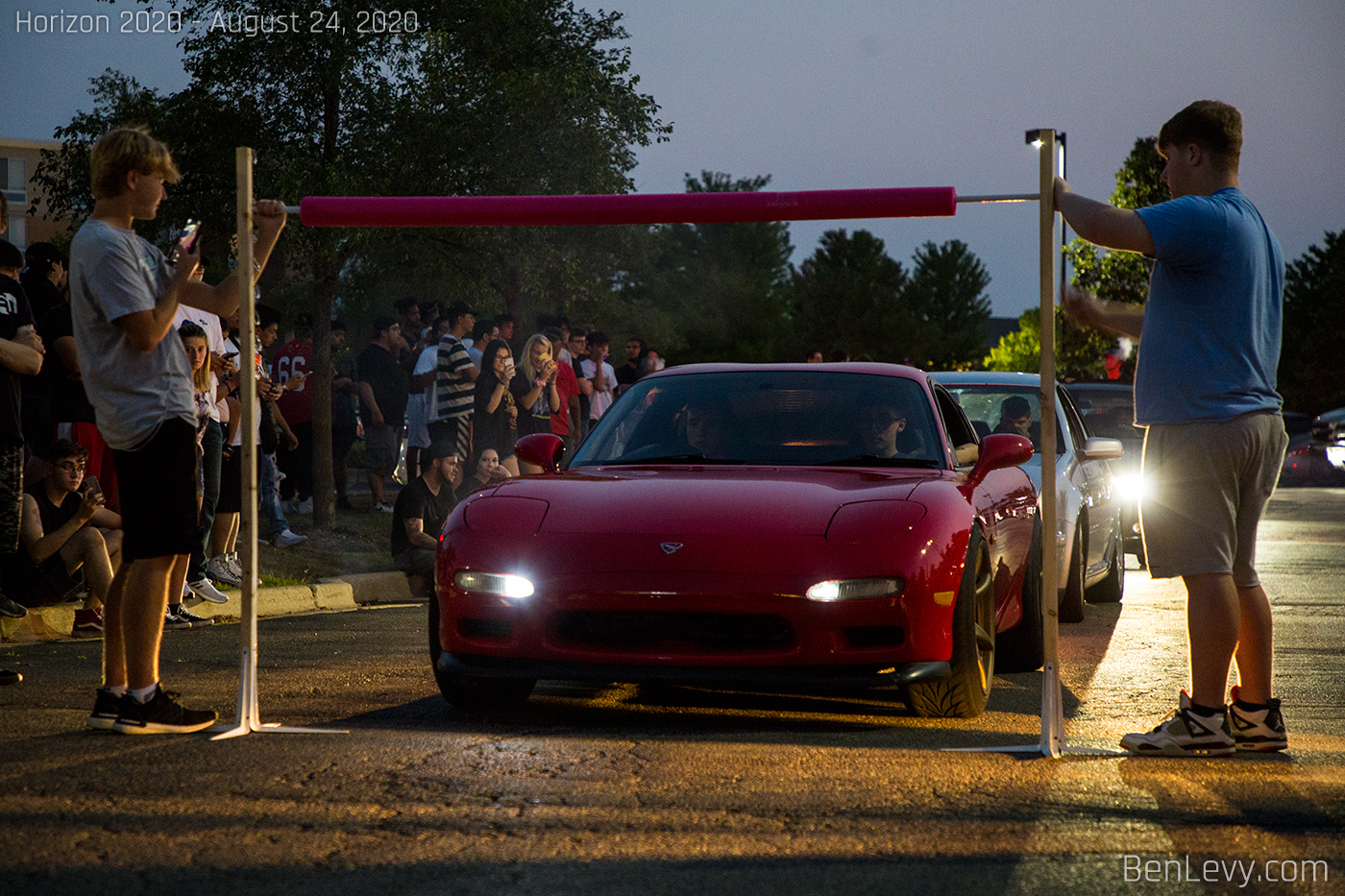 Mazda RX-7 going under the limbo bar