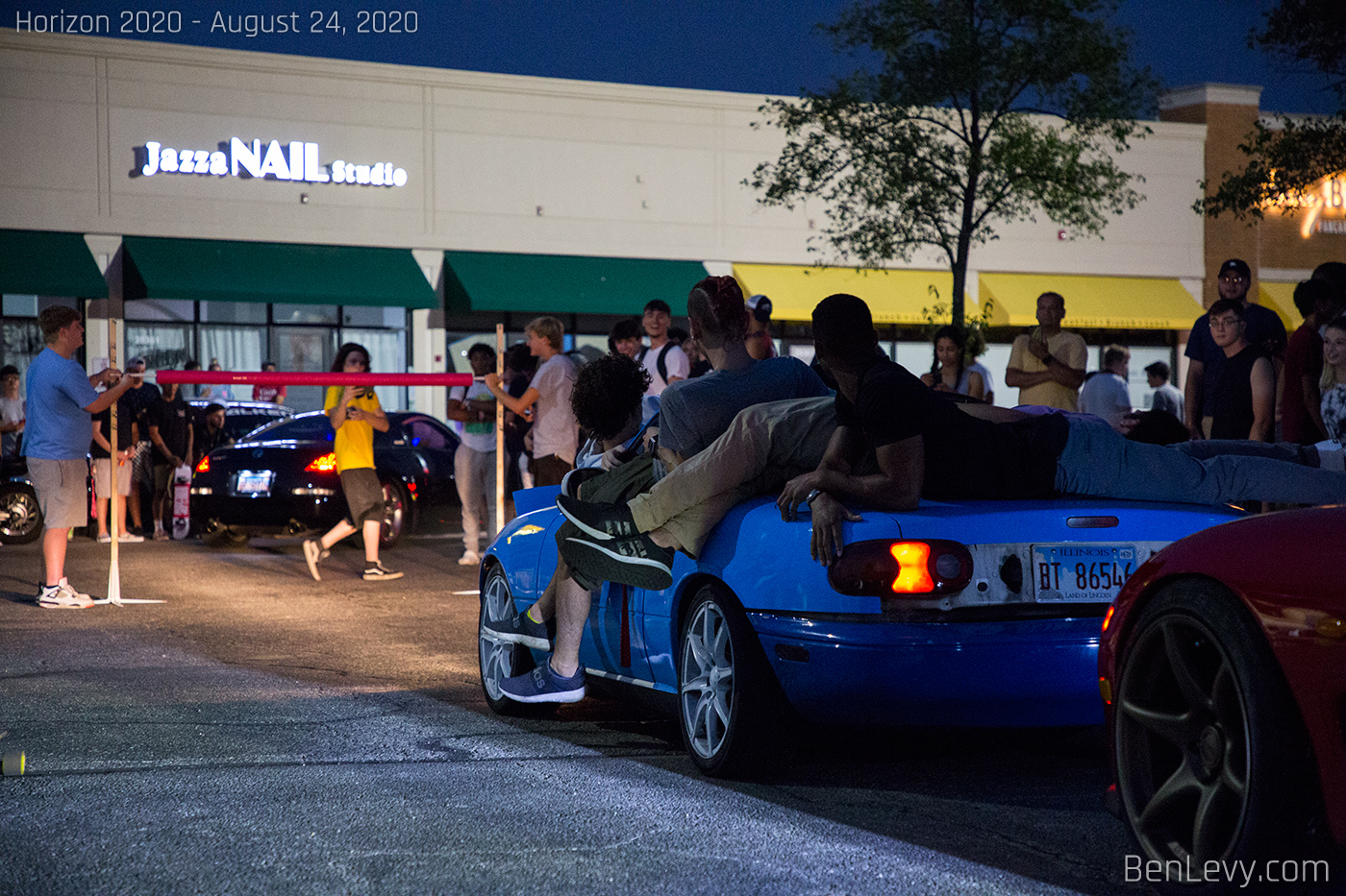 Kids piling onto Miata in limbo contest