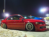 Red Lancer Evo sitting on airbags
