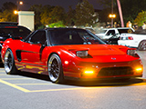 Red First gen Acura NSX with the lights up