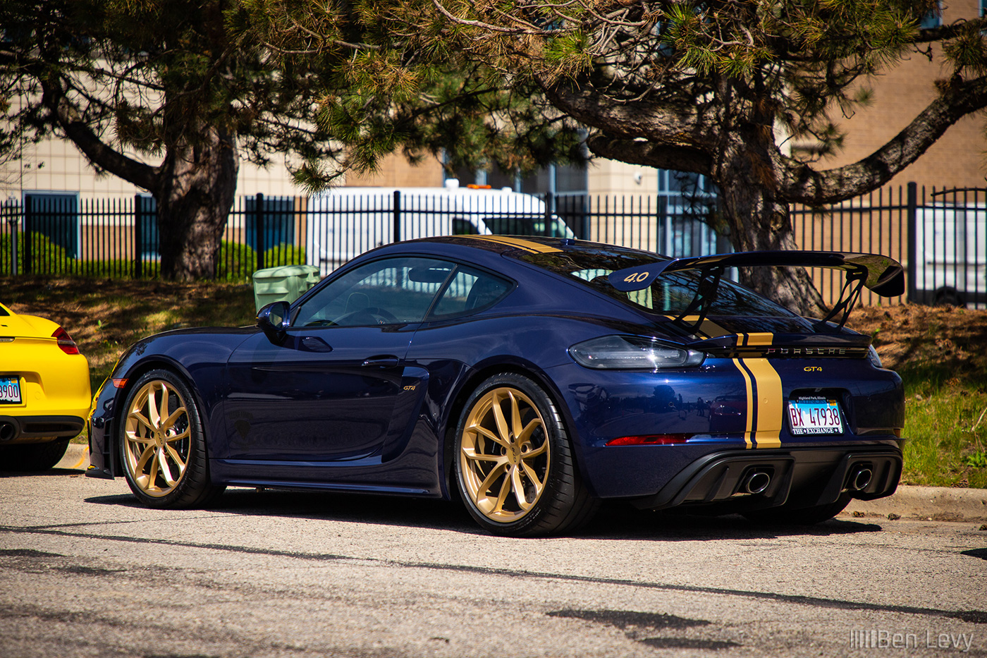 Blue Porsche 718 Cayman GT4 with Gold Stripe