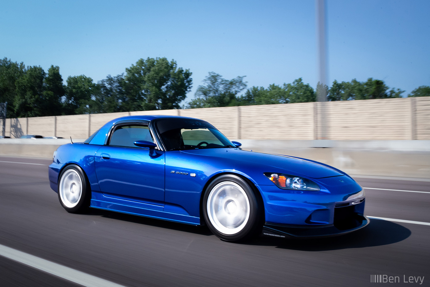 Blue Honda S2000 rolling on the highway