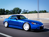 Blue Honda S2000 rolling on the highway