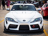 Front of White A90 Supra with Artisan Spirits hood