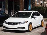 White Honda Civic with gold wheels