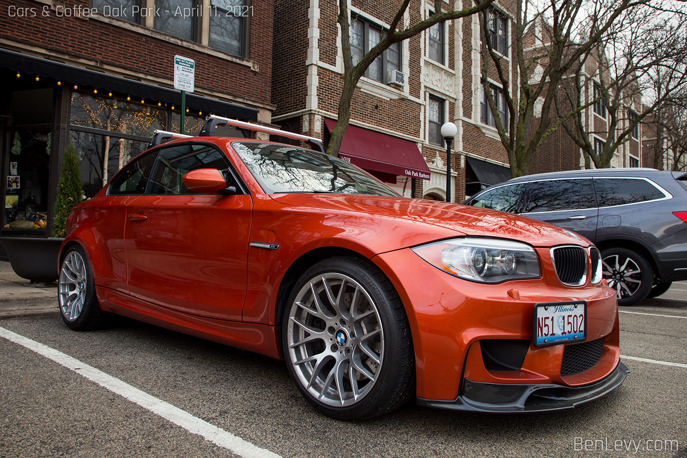 Orange BMW 1M Coupe with front lip