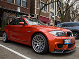 Orange BMW 1M Coupe with front lip