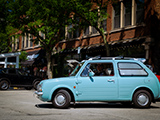 Blue Nissan Nissan Pao at Cars & Coffee Oak Park