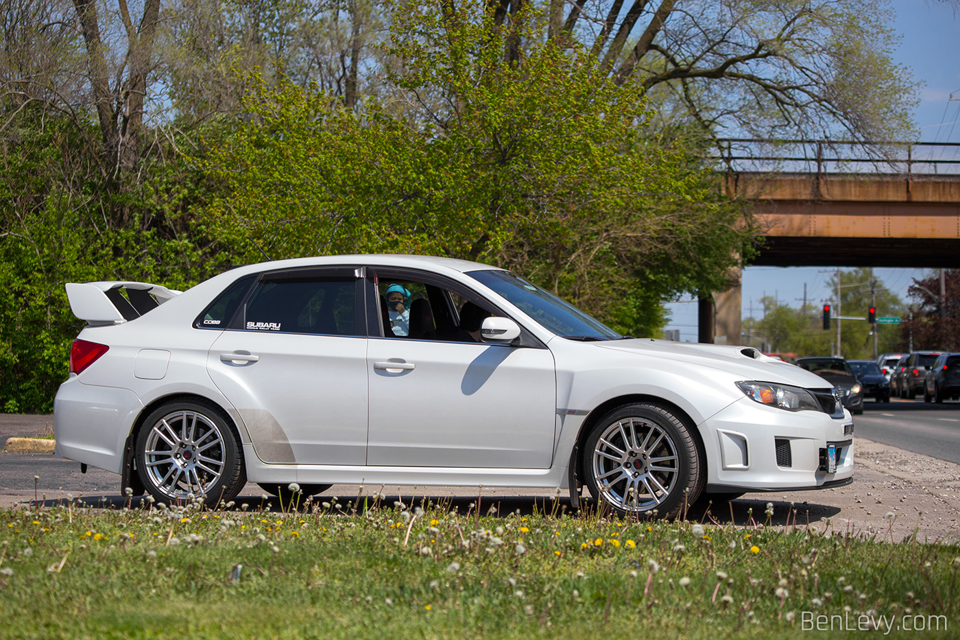 Side of White Subaru WRX STI leaving P&L Motorsports