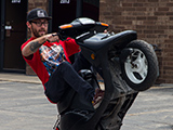 Justin Bianco doing a Wheelie on a Scooter