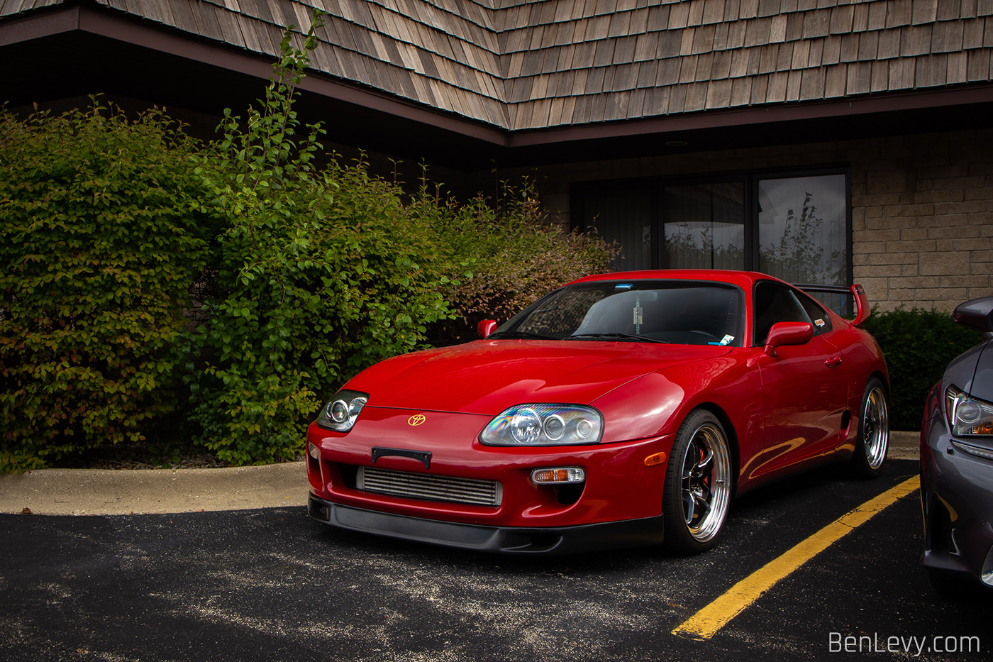Red Mk4 Toyota Supra outside of Executive Motor Carz