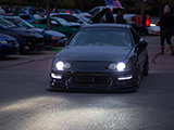 Black Acura Integra driving at night