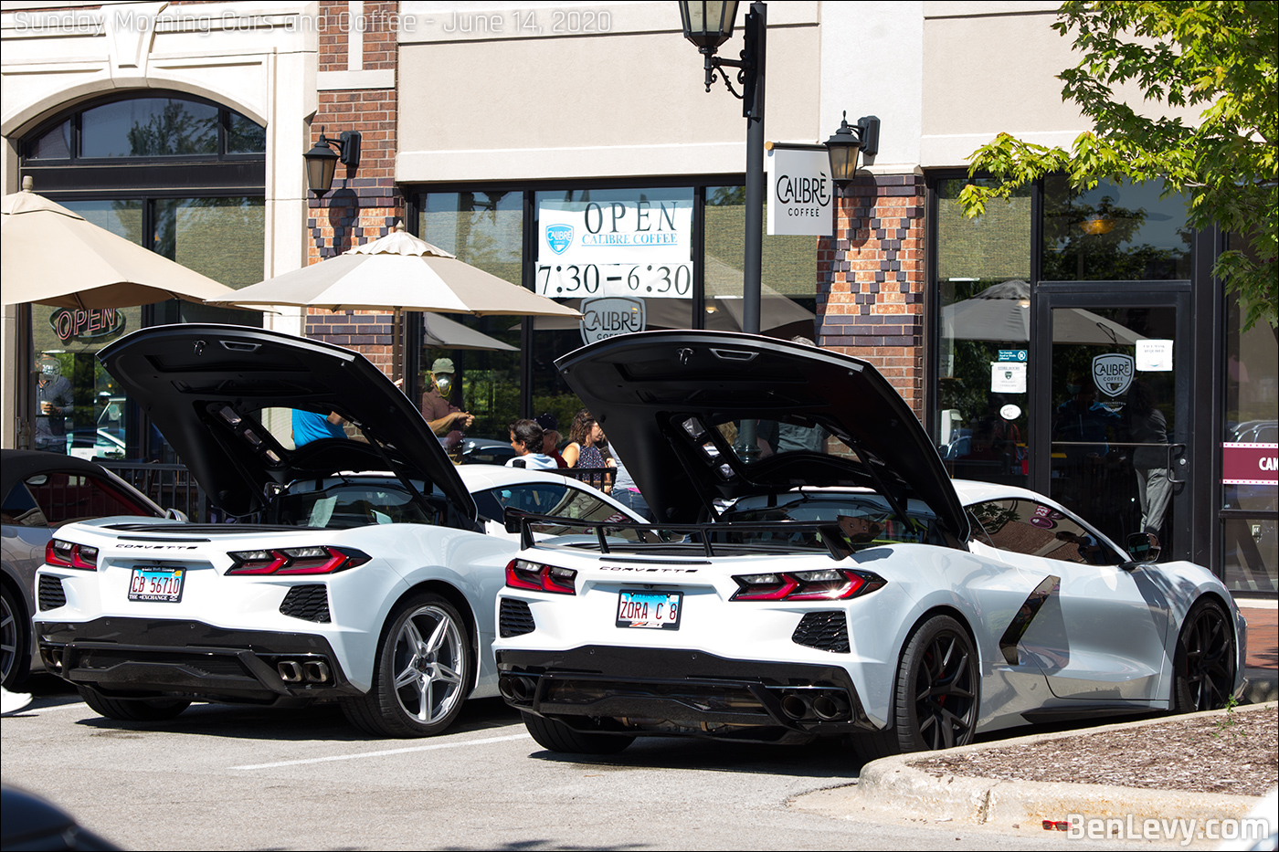 Pair of white C8 Corvettes