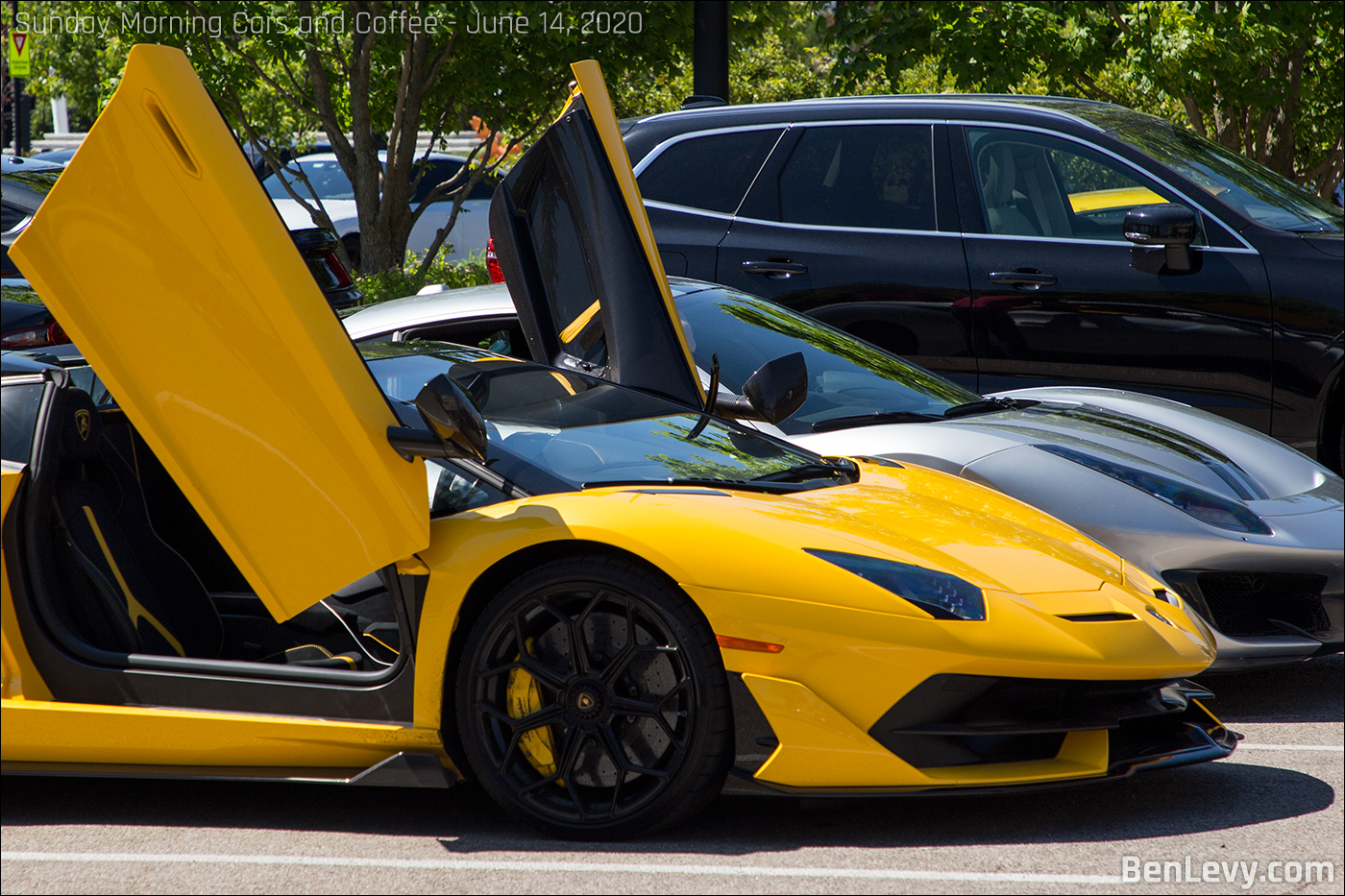 Yellow Lamborghini Aventador SVJ with doors up