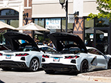 Pair of white C8 Corvettes