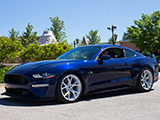 Blue Ford Mustang GT with white wheels