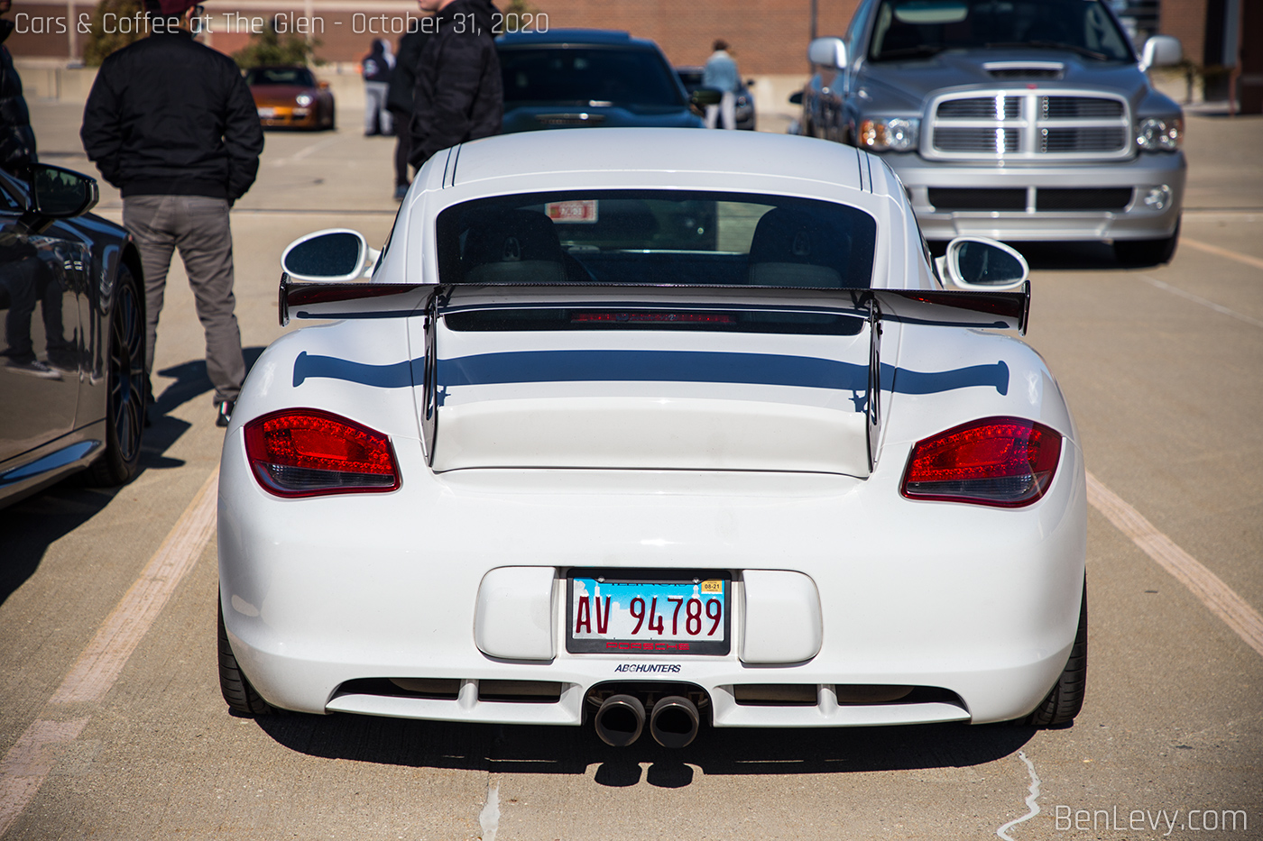 Rear of white 987 Cayman S on air suspension