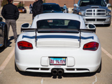 Rear of white 987 Cayman S on air suspension