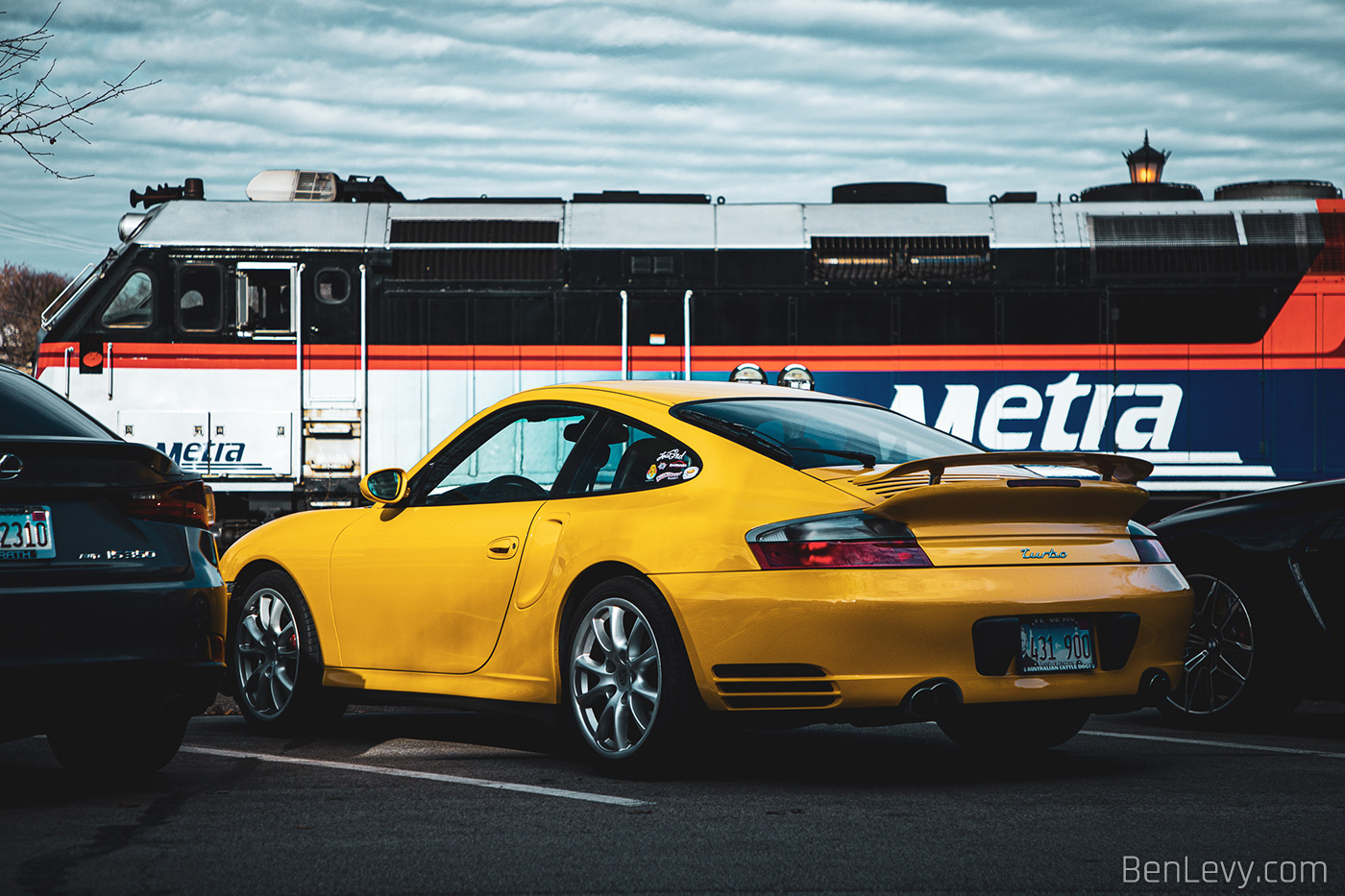 Yellow Porsche 911 Turbo and a Metra Train