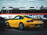 Yellow Porsche 911 Turbo and a Metra Train