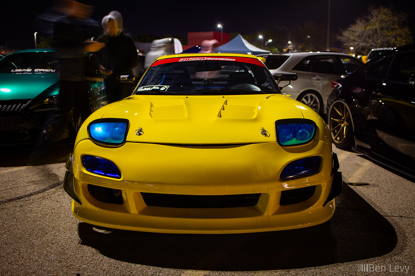 Front of a Yellow Mazda RX-7 at car meet in Aurora