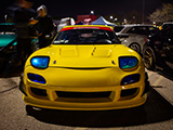 Front of a Yellow Mazda RX-7 at car meet in Aurora