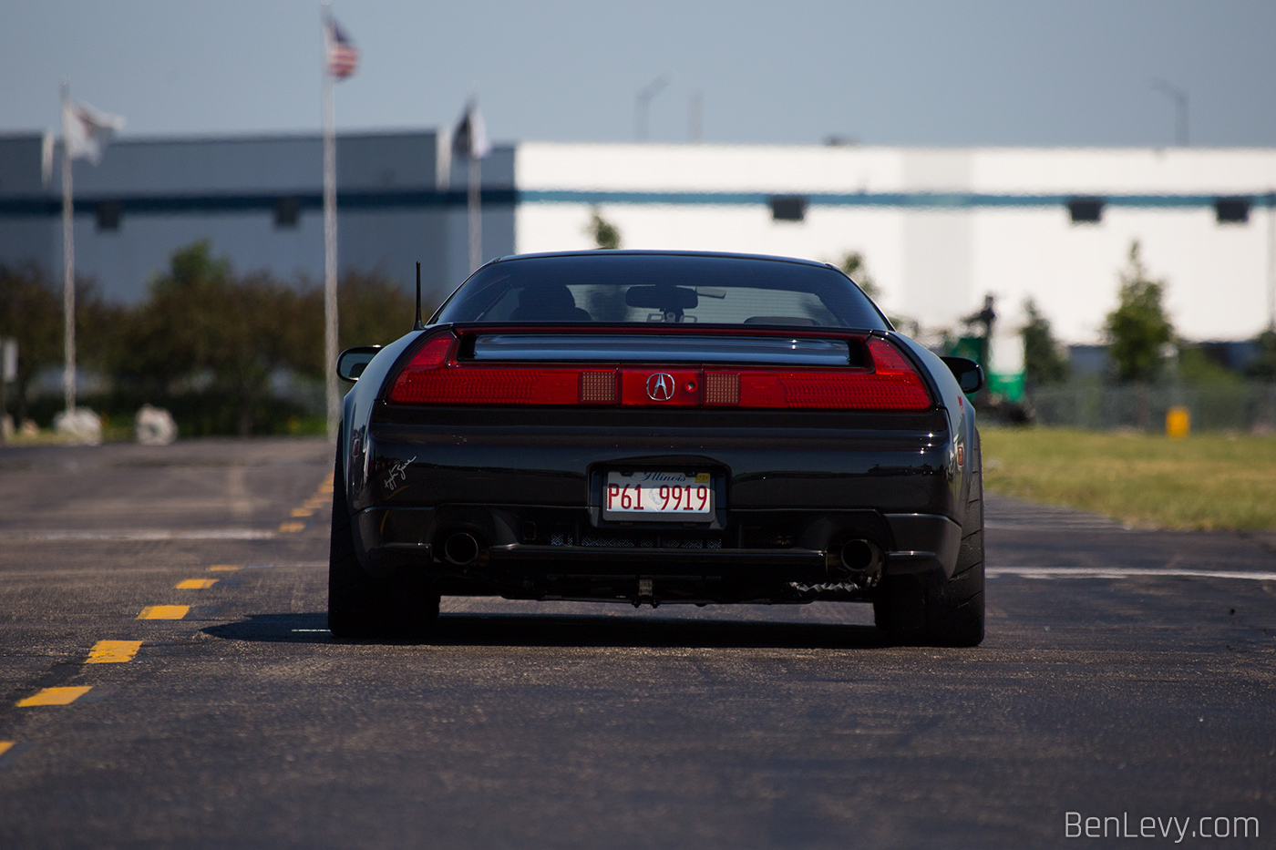 Rear of a black Acura NSX on a hot track day