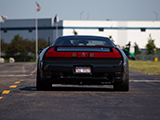 Rear of a black Acura NSX on a hot track day
