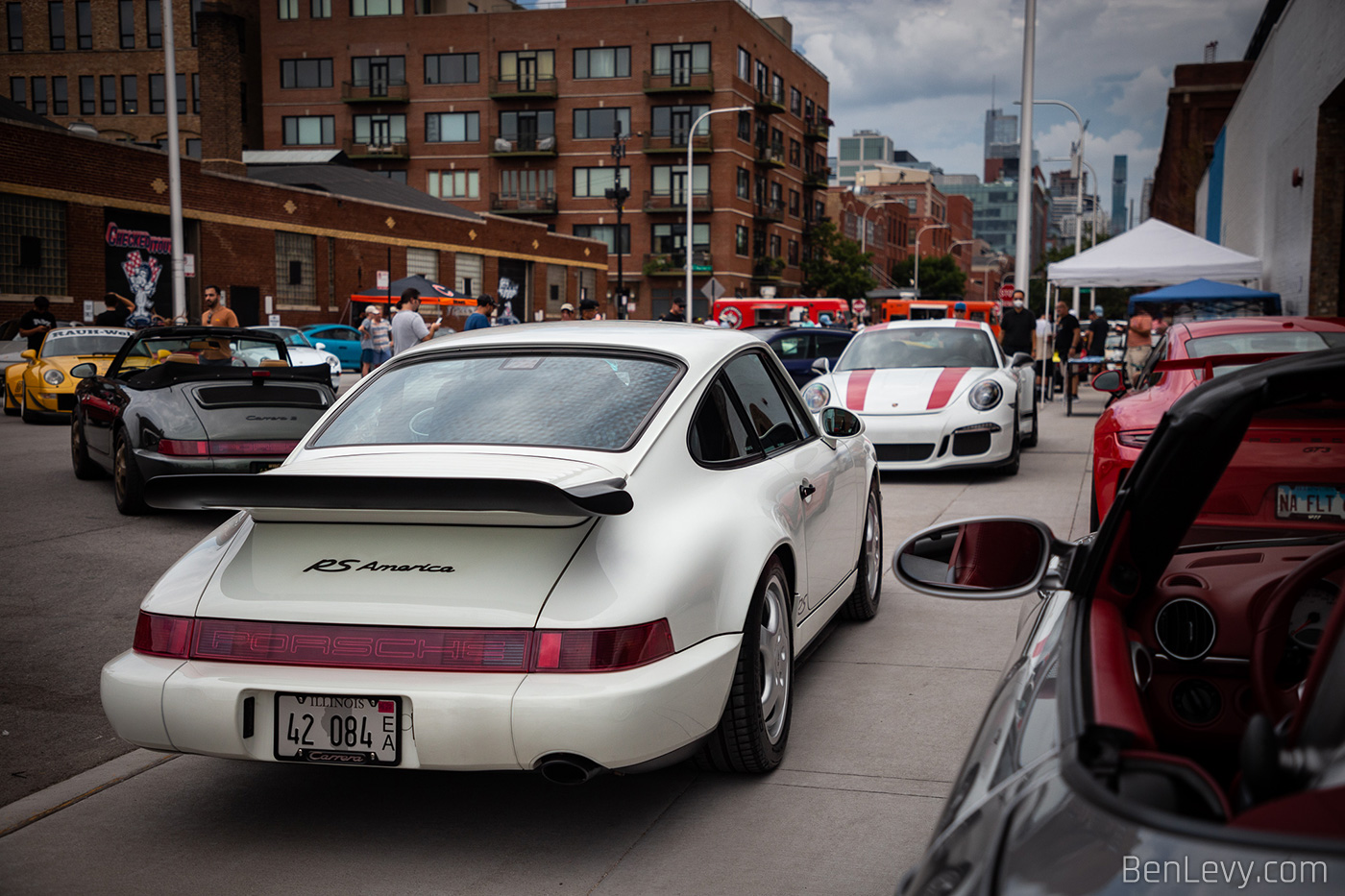 White Porsche 911 RS America parked on the sidewalk for Checkeditout 2021