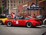 Red Porsche 911 with Roads United Sticker
