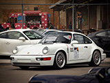 White Porsche 911 with Roads United sticker