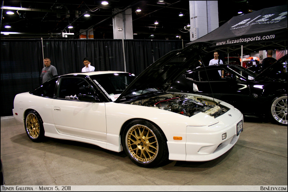 White 240SX Hatchback with Gold Wheels