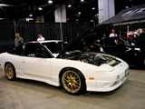 White 240SX Hatchback with Gold Wheels