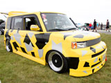 Yellow Scion xB with Abstract Geometric Pattern