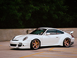 White Porsche 911 Passing Through Parking Lot