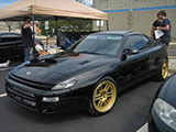 Black Toyota Celica on Gold Enkei RPF1 Wheels