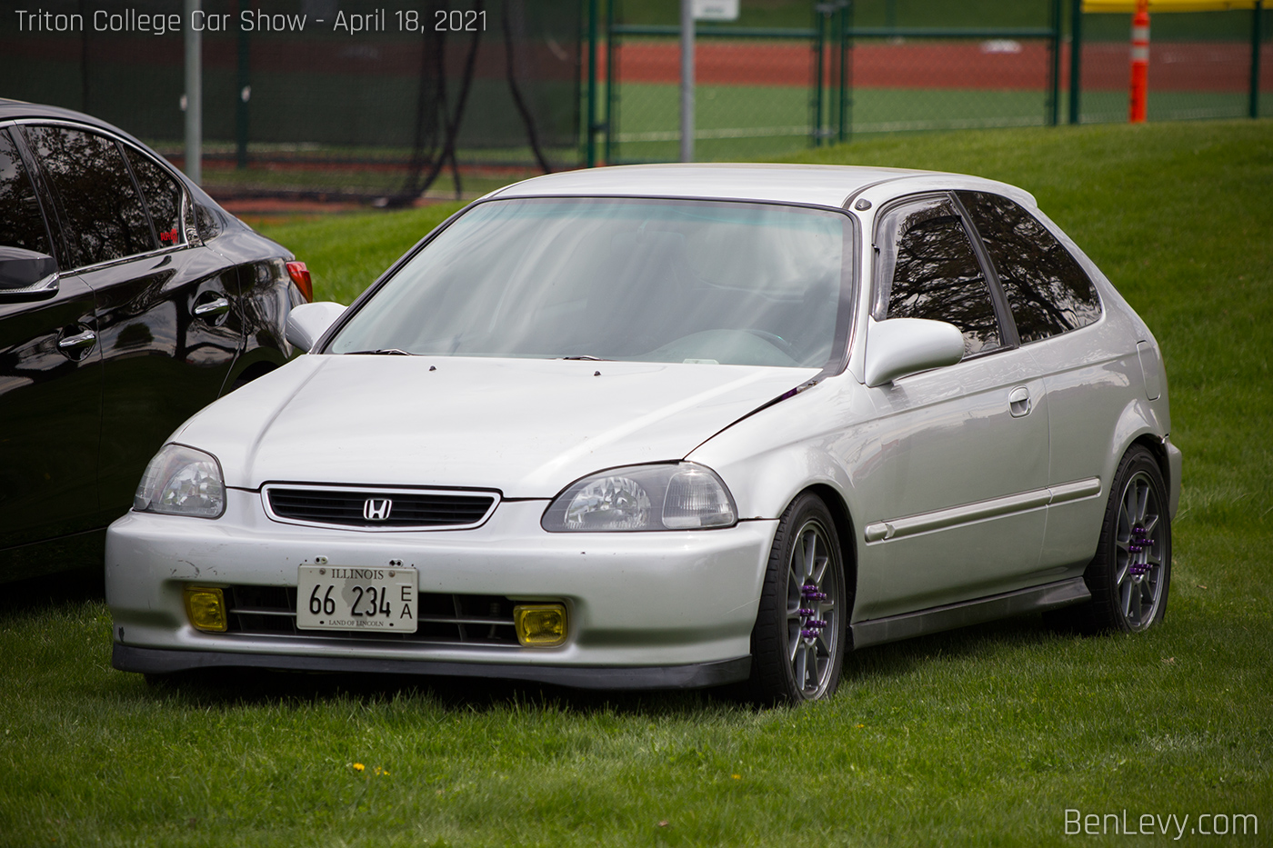 Silver Honda Civic Hatchback parked in a field