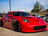 Red Nissan 370Z with custom hood and fenders