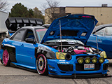 Blue Subaru WRX STI with rally lights
