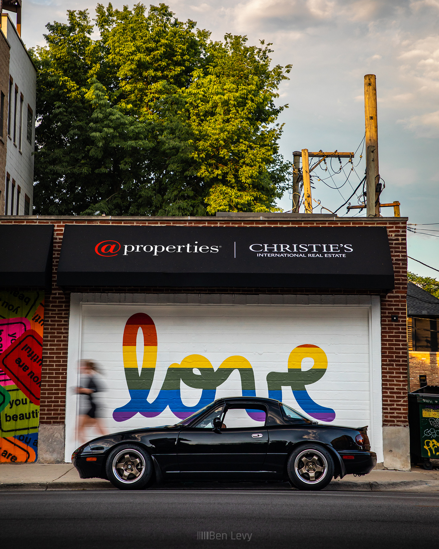 Black Miata in front of Love mural in Chicago