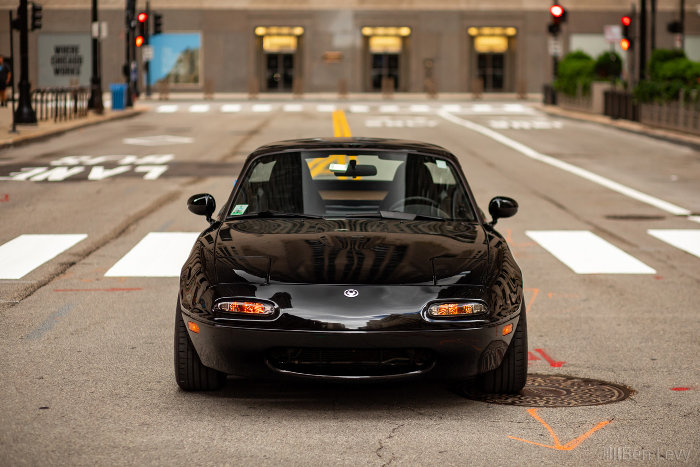 Black Mazda Miata in the center of LaSalle Street in Chicago