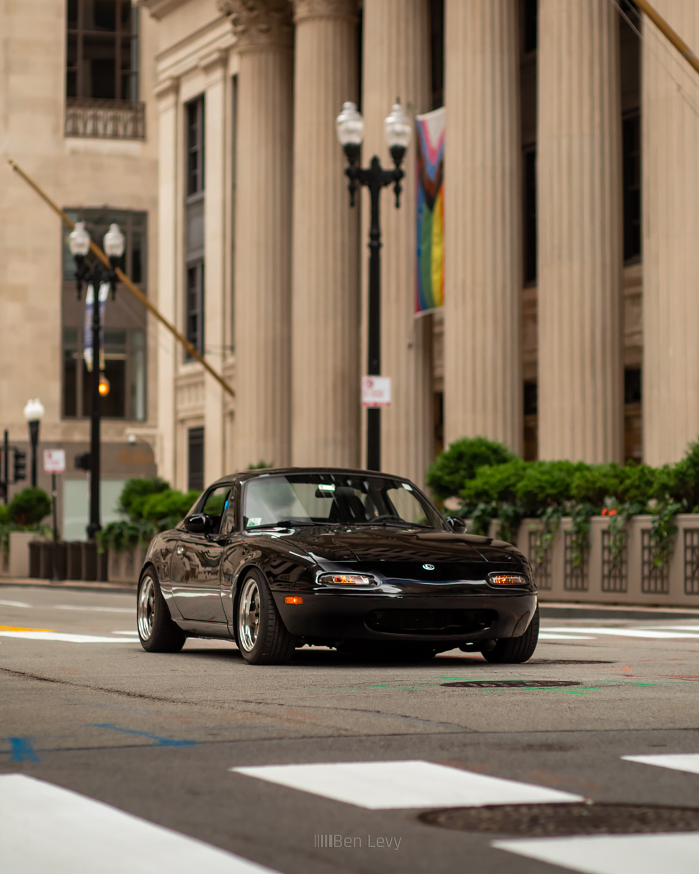 NA Miata with the Chicago Fed in the back