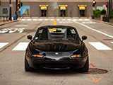 Black Mazda Miata in the center of LaSalle Street in Chicago