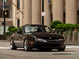 NA Miata with the Chicago Fed in the back