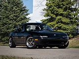 Black Miata with Some Evergreen Trees in the Background