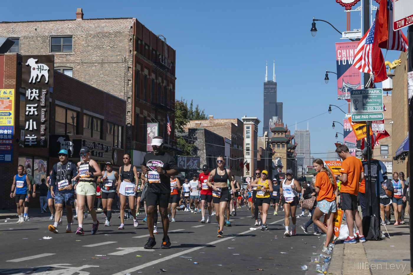 Runners in the Chicago Marathon heading down Wentworth Avenue in Chinatown