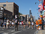 Runners in the Chicago Marathon heading down Wentworth Avenue in Chinatown